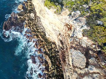 High angle view of rocks in sea