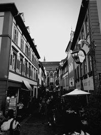 People on street in city against clear sky