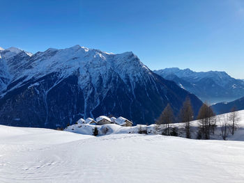 Scenic view of snow covered mountains against sky