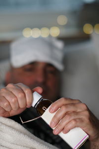 Close-up of man taking syrup