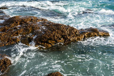 High angle view of rocks in sea