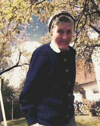 Portrait of senior woman standing in yard