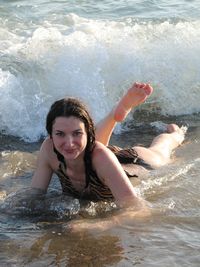 Portrait of smiling young woman swimming in sea