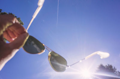 Low angle view of black glasses against clear sky