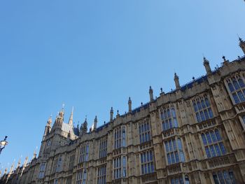 Low angle view of buildings against blue sky