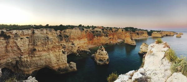 Scenic view of sea and rocks against sky