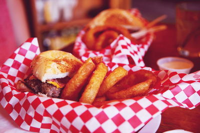 Close-up of onion rings with burger