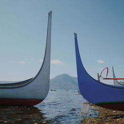 Sailboats moored in sea