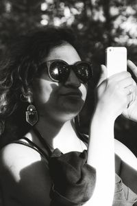 Close-up portrait of woman wearing sunglasses