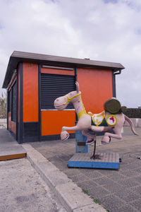 Man with umbrella against sky