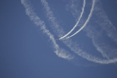 Low angle view of airplane flying in sky