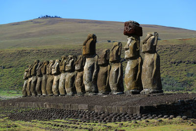 Statues on landscape against the sky