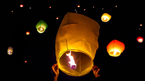 Low angle view of lantern against sky at night