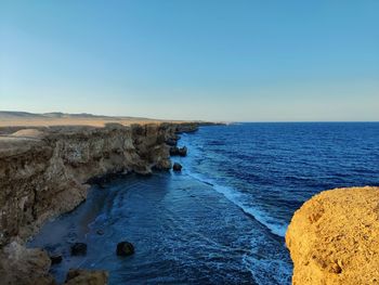 Scenic view of sea against clear blue sky