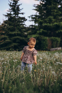 Side view of young woman standing on field