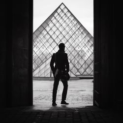 Rear view of silhouette man standing in building