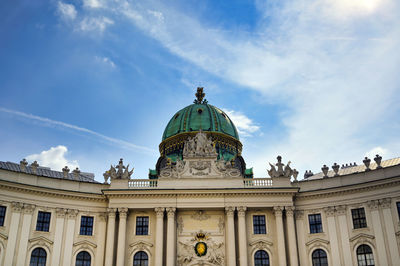 Low angle view of building against cloudy sky