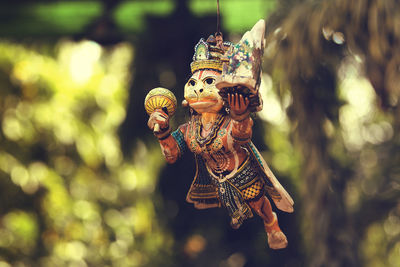 Close-up of hanuman figurine hanging outdoors