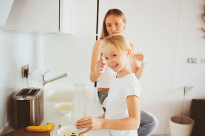 Portrait of a smiling young woman at home