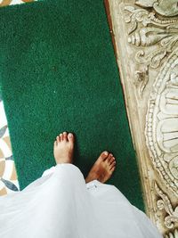 Low section of woman standing on tiled floor