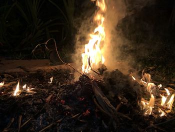Close-up of bonfire on field at night