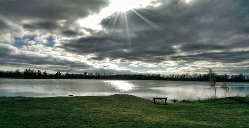 Scenic view of river against cloudy sky