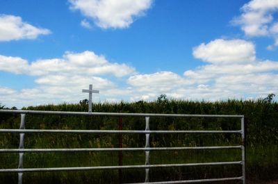 Fence on field against sky