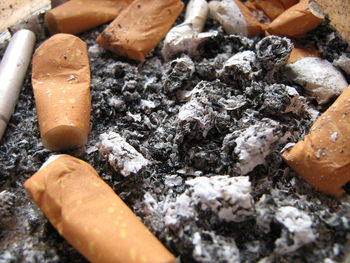 High angle view of cigarette smoking on wood