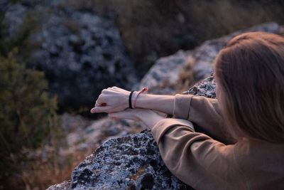 High angle view of woman standing by stone wall