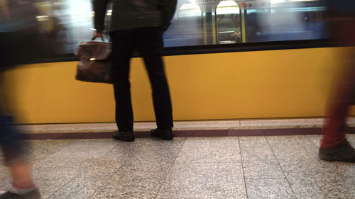 Low section of people standing on railroad station platform