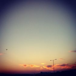Low angle view of silhouette trees against sky at sunset