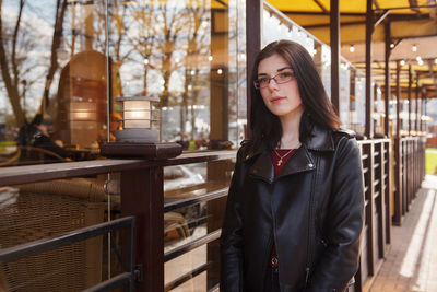 Portrait of beautiful young woman standing outdoors