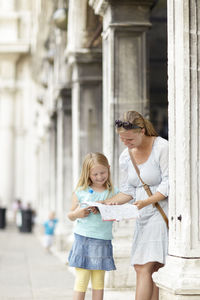 Mother and daughter reading map