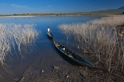 High angle view of man on lake against sky