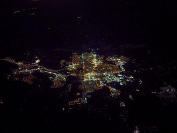 Aerial view of illuminated city at night