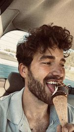 Close-up portrait of man eating food