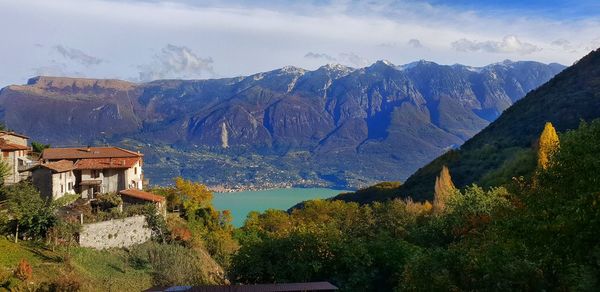 Panoramic view of buildings and mountains against sky