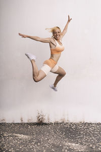 Isolated female athlete jumping outdoors