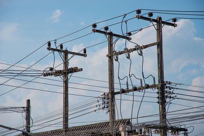 Low angle view of electricity pylon against sky