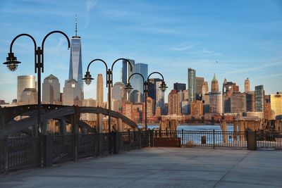 Cityscape by river seen from footpath