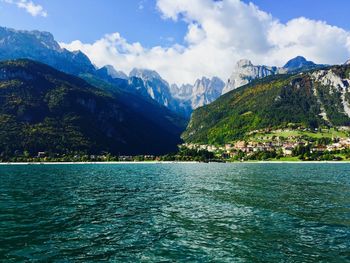 Scenic view of lake and mountains against sky