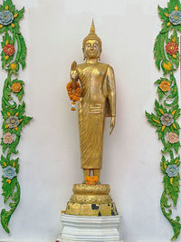 Statue of temple against building