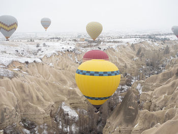 Hot air balloons flying over rocks