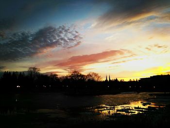 Scenic view of lake against romantic sky at sunset