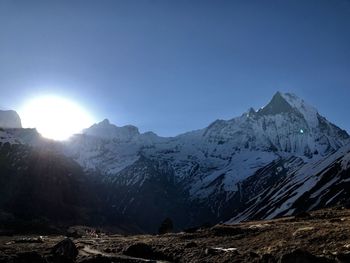 Scenic view of snowcapped mountains against clear sky