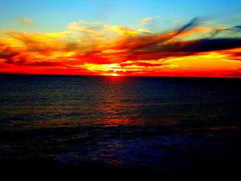 Scenic view of sea against romantic sky at sunset