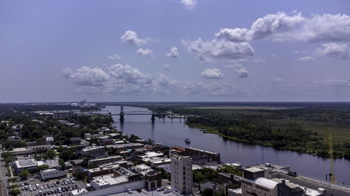 High angle view of buildings by sea against sky