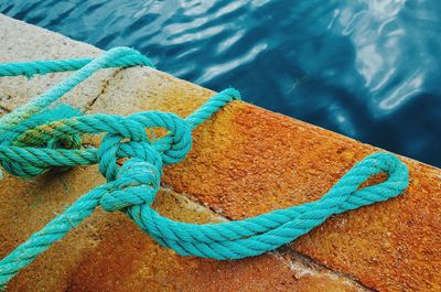 High angle view of tangled turquoise rope on pier