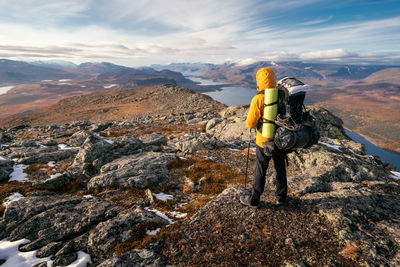 Rear view of woman walking on mountain