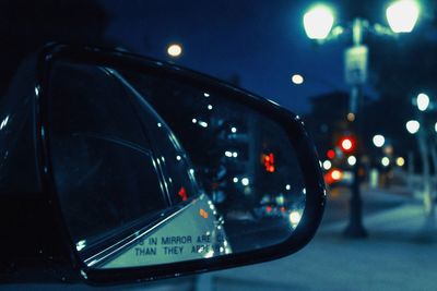 Close-up of illuminated cars in city at night